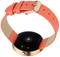 'Smartwatch with a round case and a bright orange strap, equipped with sensors on the back for fitness tracking.'