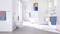 Bright, modern bathroom with a freestanding bathtub, shower area, washbasin and toilet. Blue and red towels provide colour accents.