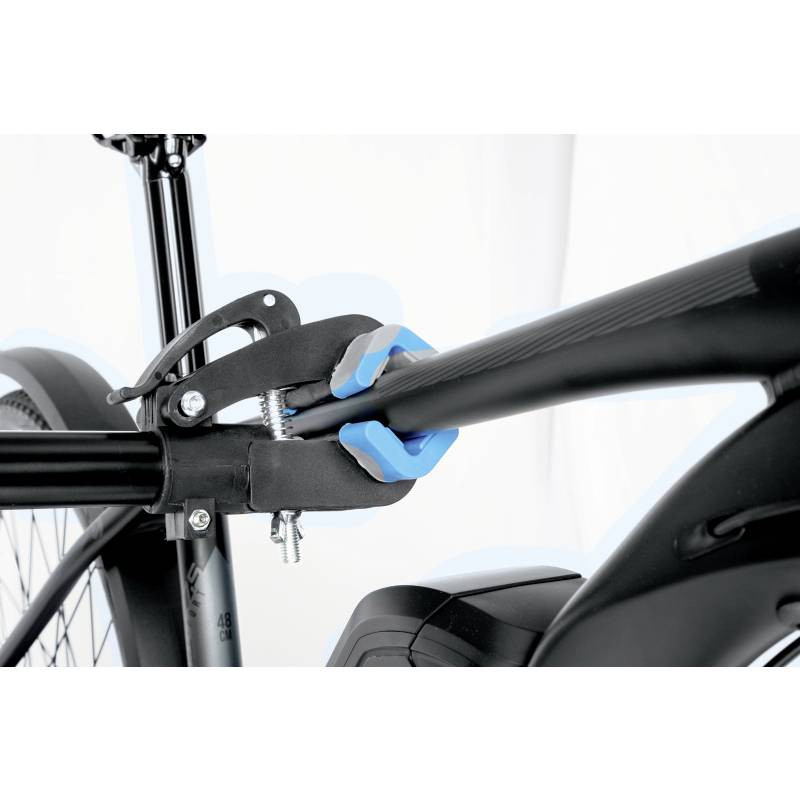 A person wearing blue gloves is attaching a bicycle clamp to a bicycle frame to secure the bike firmly.