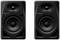 Two black Pioneer DJ speakers with a minimalist design. They each feature a large and a small speaker.