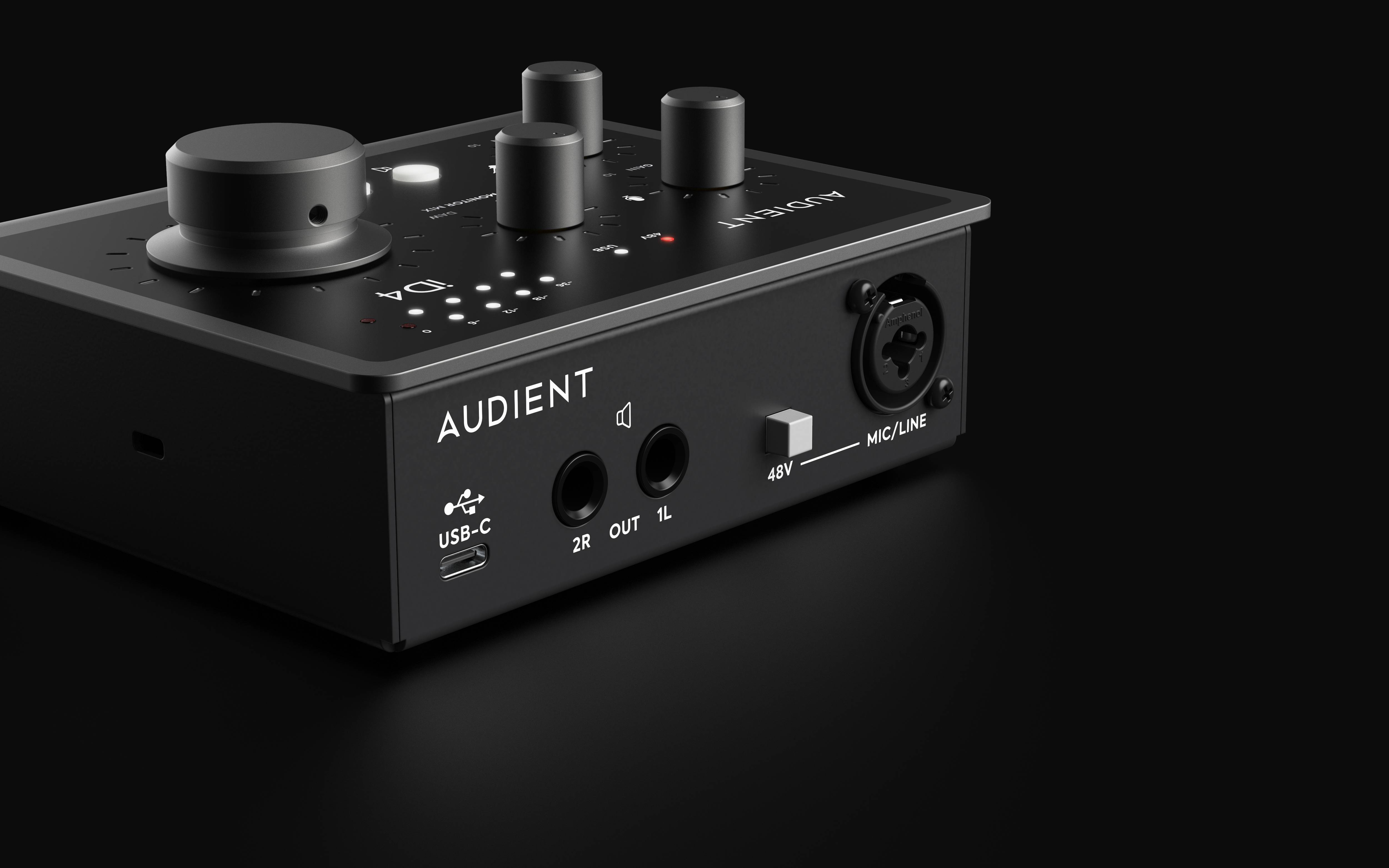 A small audio interface with multiple rotary knobs and connections, including USB-C and microphone input; brand 'Audient'.