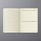 An open notebook on a grey background with a monthly calendar, space for habits and notes.