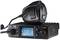 A black radio transceiver with a microphone. The display shows 'FM 07' and frequency information. Control buttons are located on the front panel.