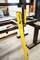 'Yellow Stabila spirit level set on a steel frame in a workshop, surrounded by tools.'