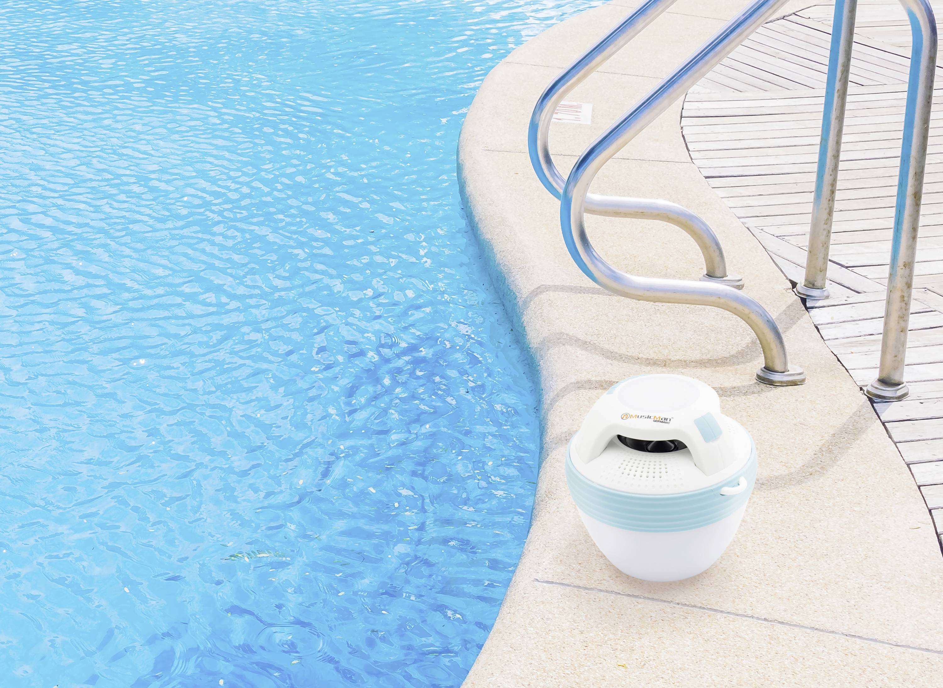A portable speaker stands at the edge of a swimming pool next to a metal ladder. The pool has clear, blue water.