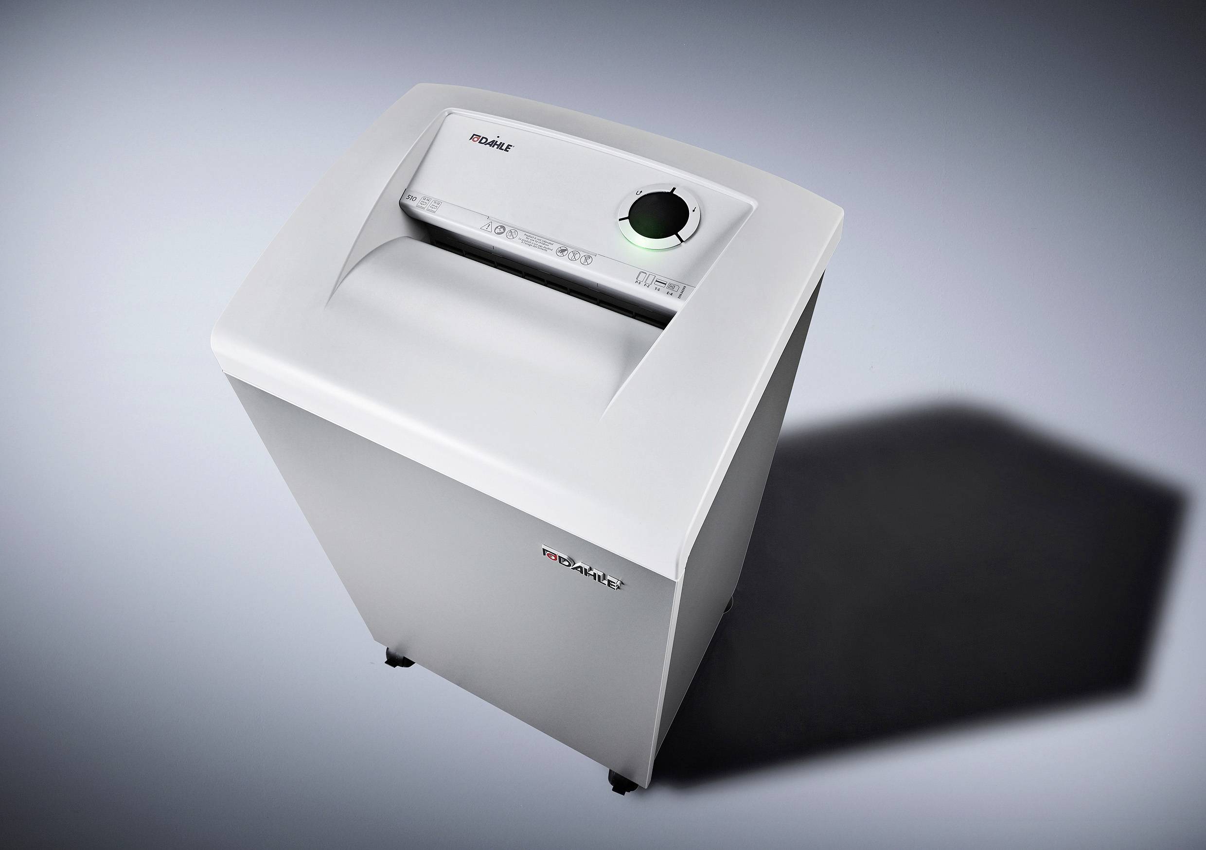 A white paper shredder on a grey background. The shredder has a control panel on top and stands on castors.