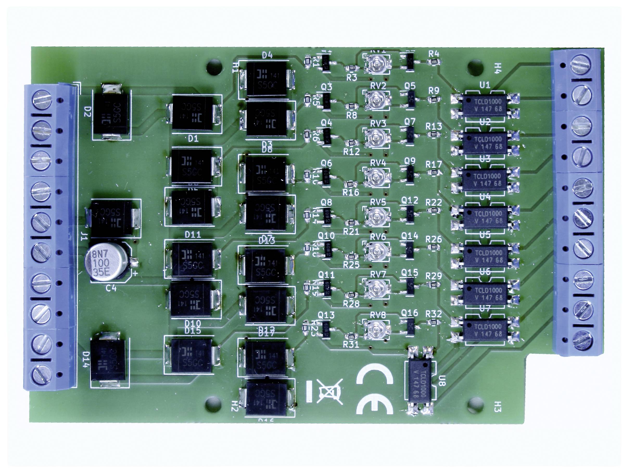 A green electronic circuit with multiple black chips and silver components, mounted on a rectangular circuit board.