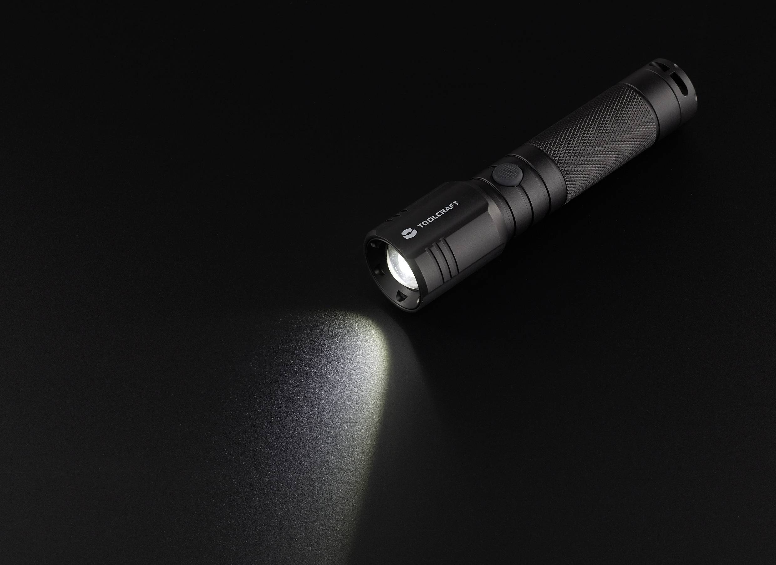 Torch shining diagonally downwards to the left against a black background.