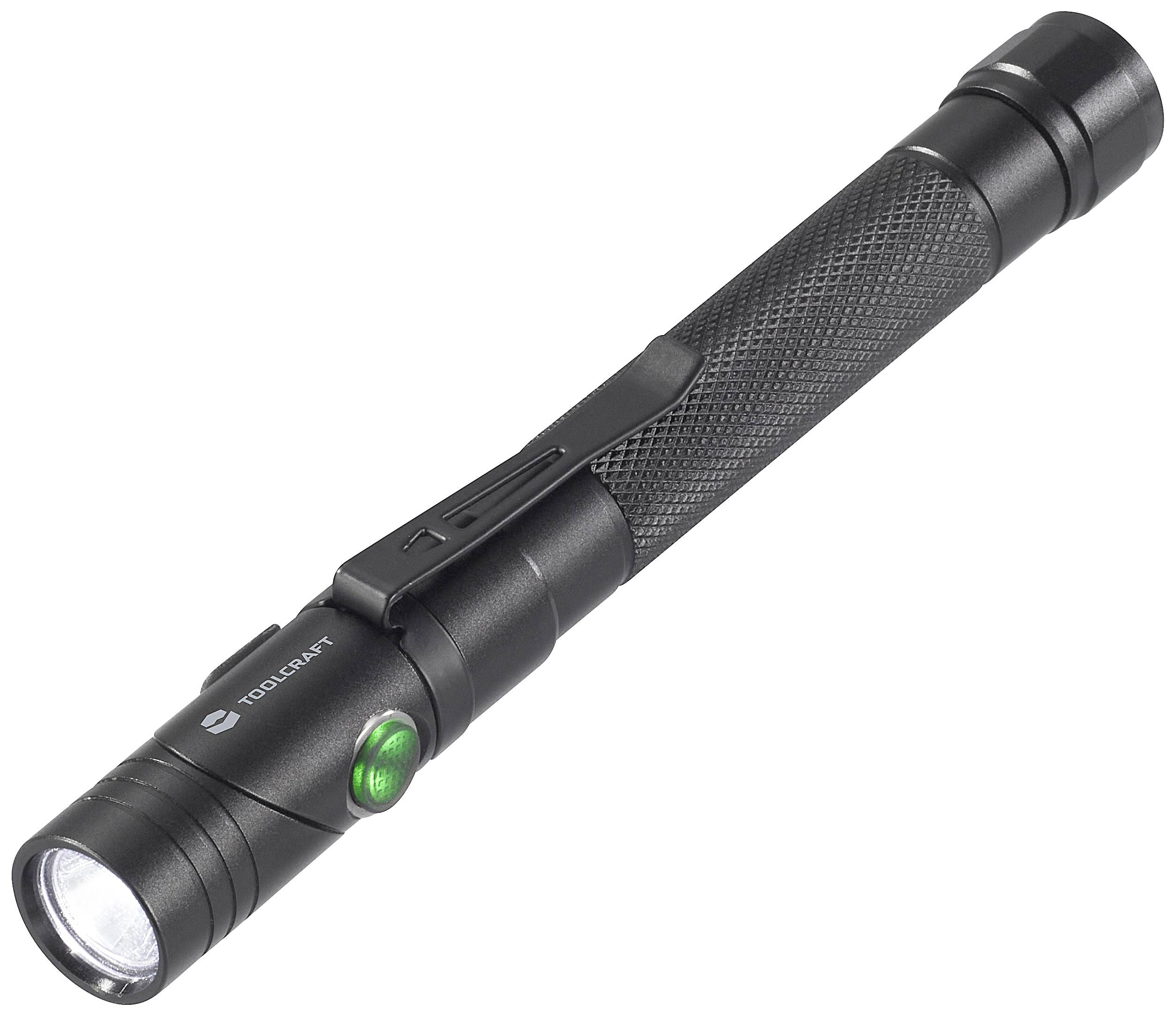 A black torch with a textured grip and a green button, illuminated, lies diagonally on a white surface.