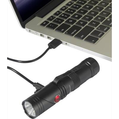 A black torch is connected to a laptop via a USB cable. The torch is not illuminating.