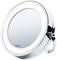 Round cosmetic mirror with LED lighting; silver design with stand; 'beurer' brand on the front.