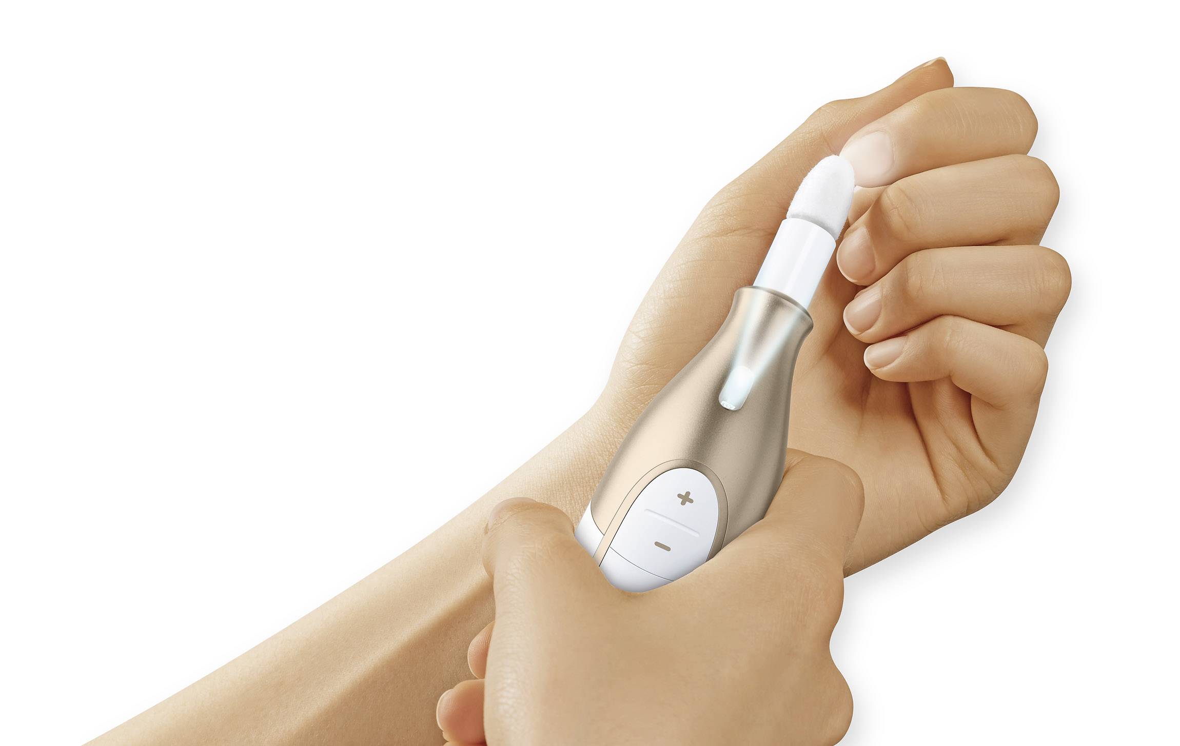 A hand is holding a medical device on a wrist. The device appears to be used for taking blood samples or skin analysis.