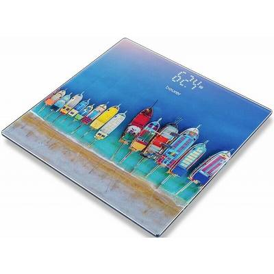 Colourful beach huts on a weighing scale. Display shows '62.4 kg'.