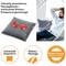 A man leans back in an armchair, gazing at a grey massage cushion on the table. Text: Versatile Shiatsu massage cushion.