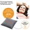 Woman smiling on a pillow with light and heat function. Text: 'Simply leave everyday life behind'.<br><br>Note: The translation maintains the original meaning and uses British English phrasing while preserving the core message of the text.