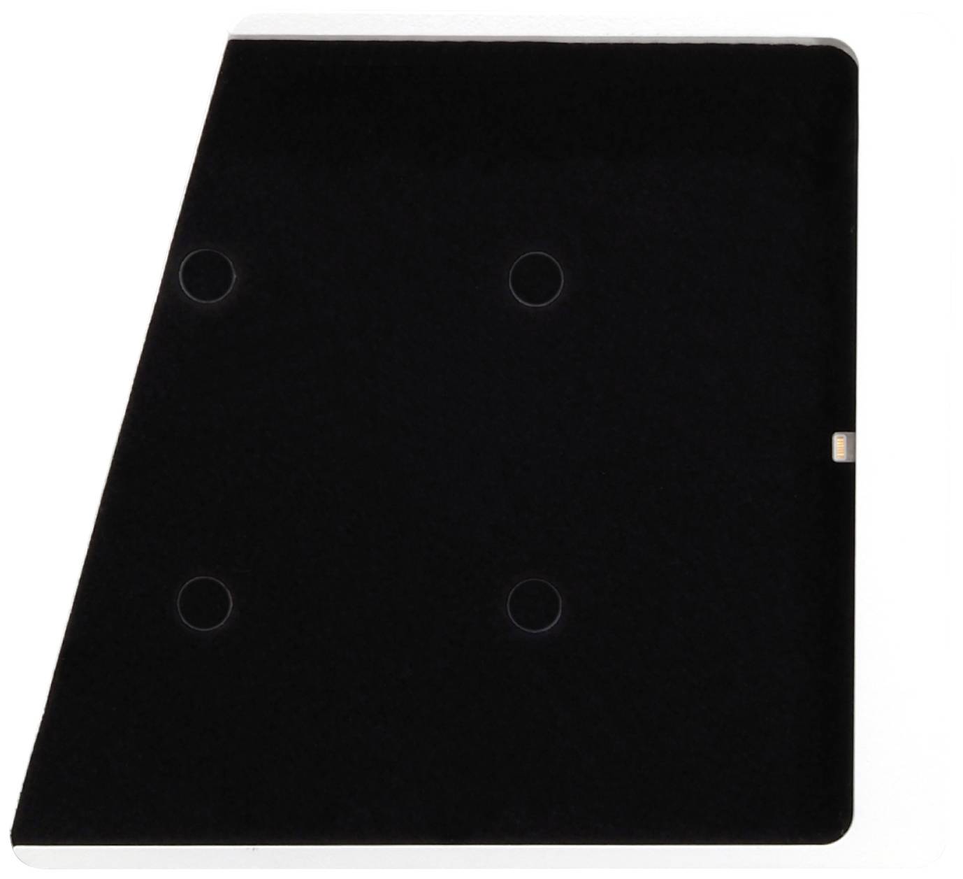 A black rectangle with a chamfered corner and four circular recesses, possibly intended as mounting points.