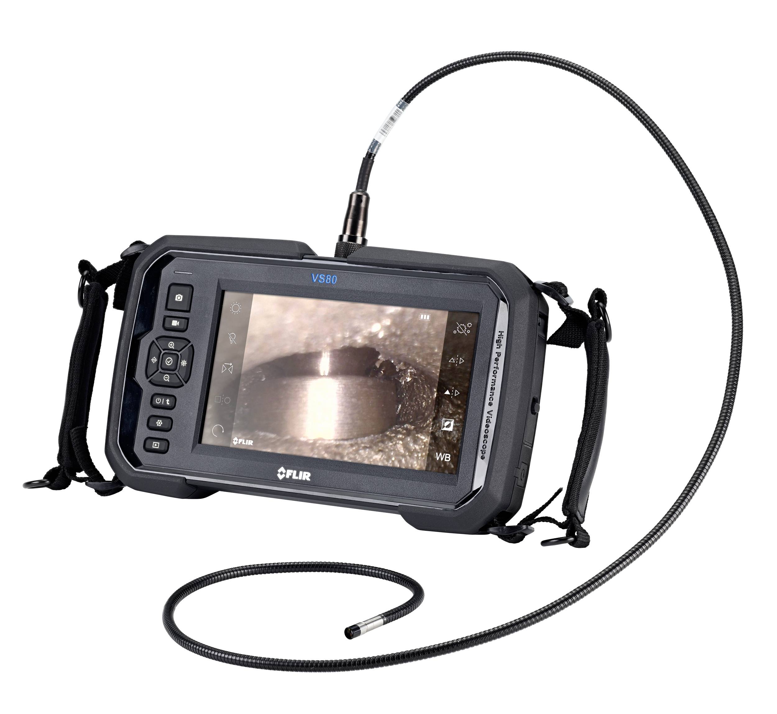 Portable video endoscope with a flexible cable and screen, showing a close-up view of a metallic object during inspection.