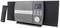 Stereo system with speakers, large volume control, screen displaying music information. Remote control placed beside it.