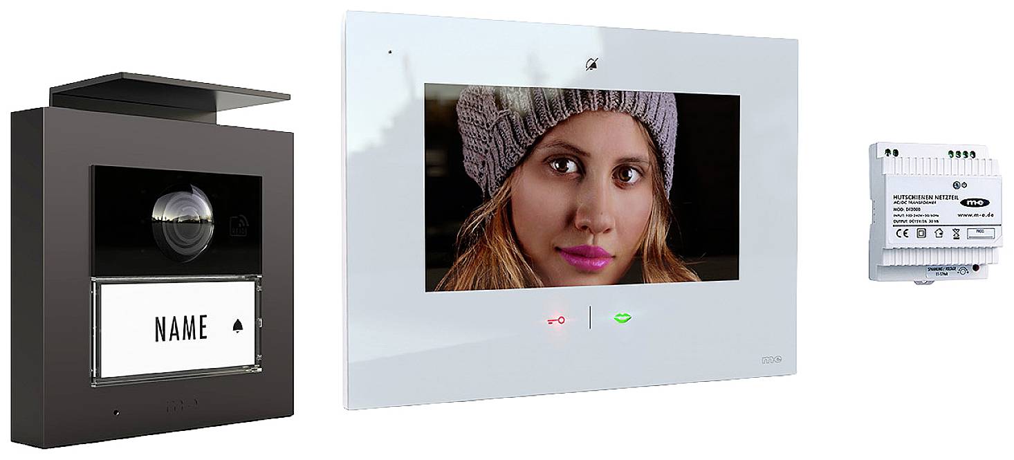 Intercom with camera and screen displays a woman wearing a cap. On the left, a doorbell, and on the right, an electronic control unit.