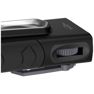 Close-up of a black electronic device with buttons and a dial on the side, possibly a control element.