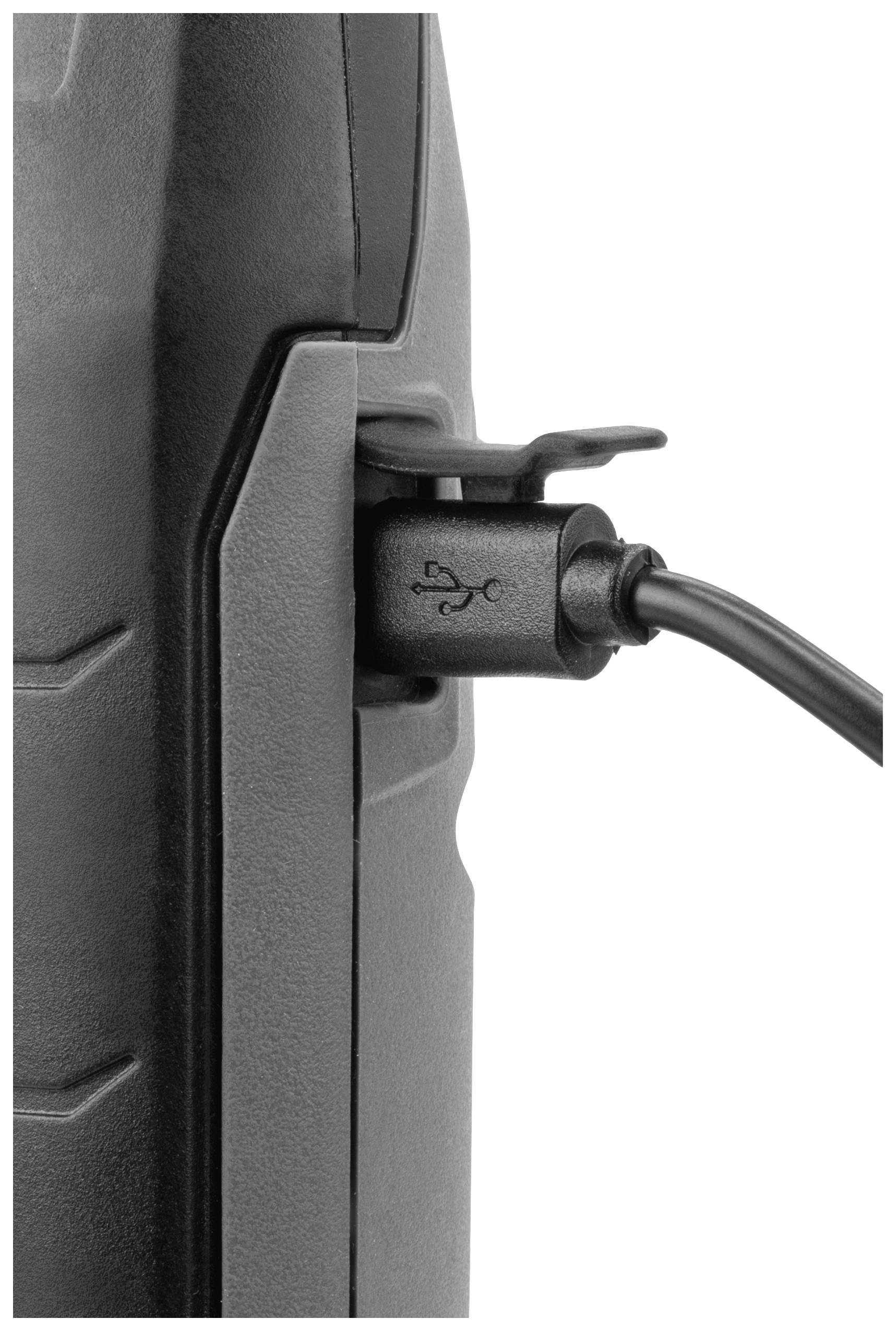 A USB cable is connected sideways to a black electronic device.