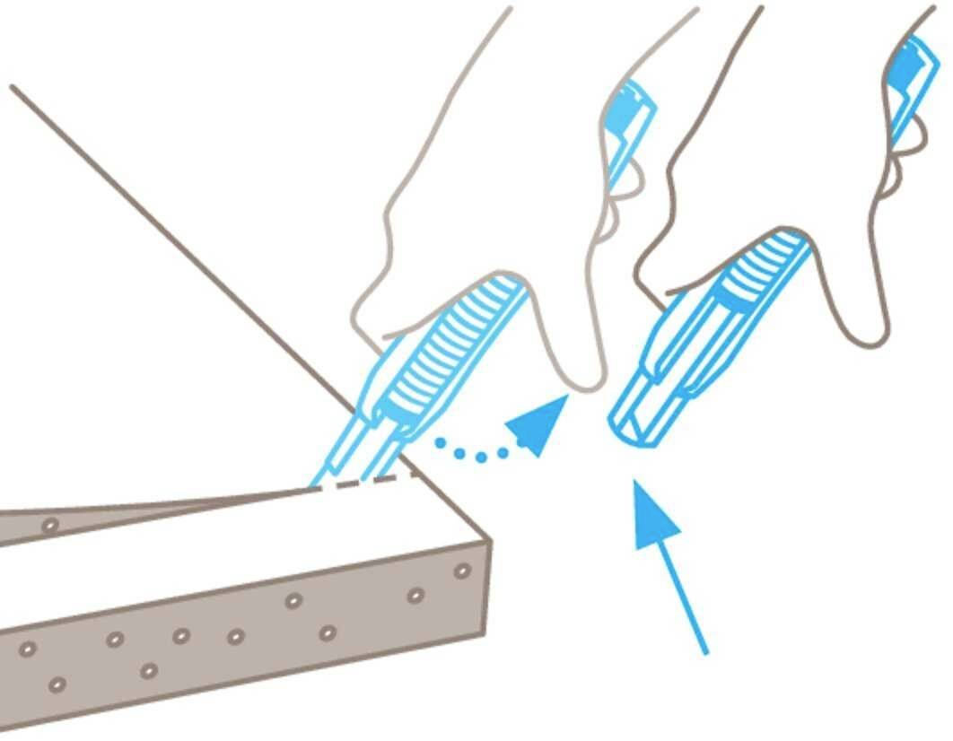 Three hands are using craft knives to cut along a marked line. Arrows indicate the cutting direction.