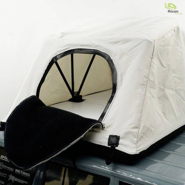 Roof tent mounted on a car, with the front flap open and the inner tent visible.