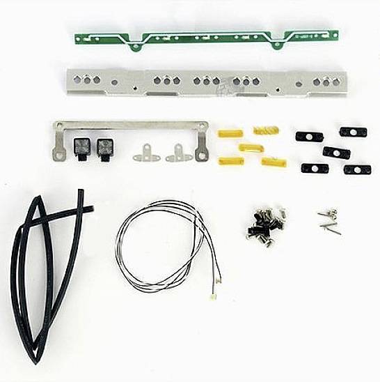 Electronic kit with cables, switches, metal plates, and small components. Main components are systematically arranged.