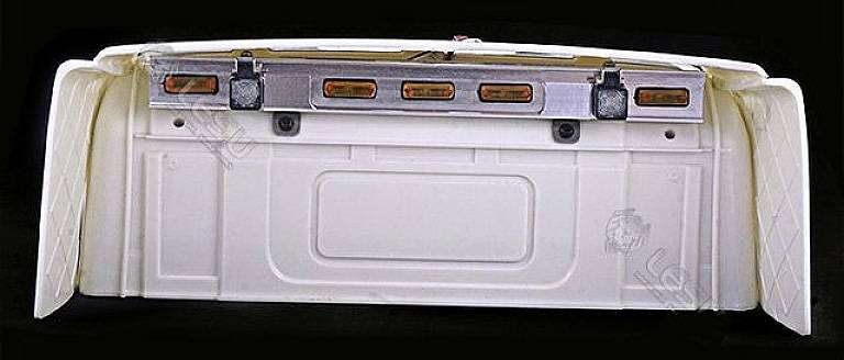 Rear loading area of a white lorry with tail lights and bumper.