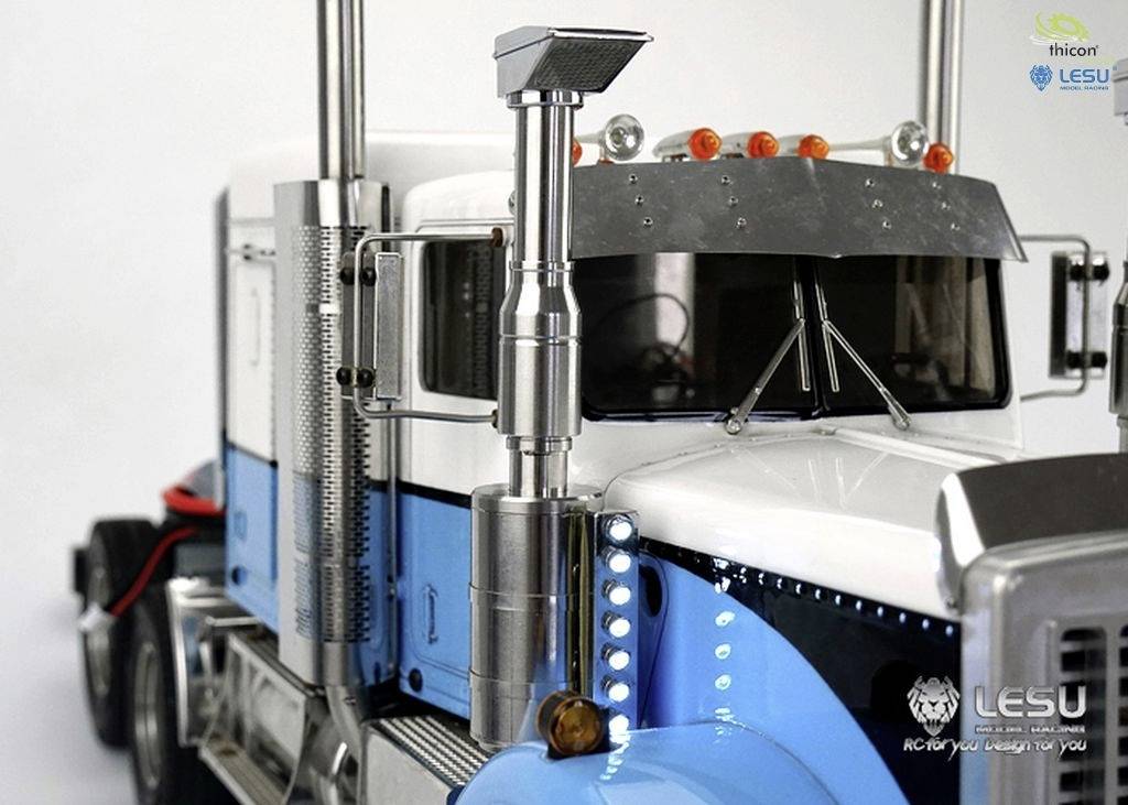 A detailed model of a lorry with a blue and white paint finish and stainless steel components. Logos for 'thicon' and 'LESU' are visible.