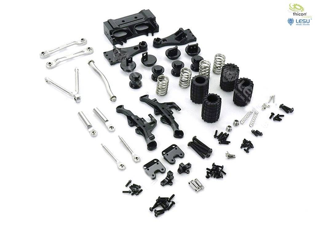 Model car components, including screws, springs, and suspension parts, laid out on a white background.