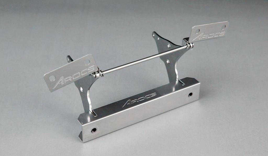 Metal component with two vertical mounting brackets and 'Arcogs' logo, presumably a technical part or bracket.