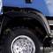 Close-up of a black wheel arch and tyre of a blue vehicle, with the 'LESU' logo printed on it.