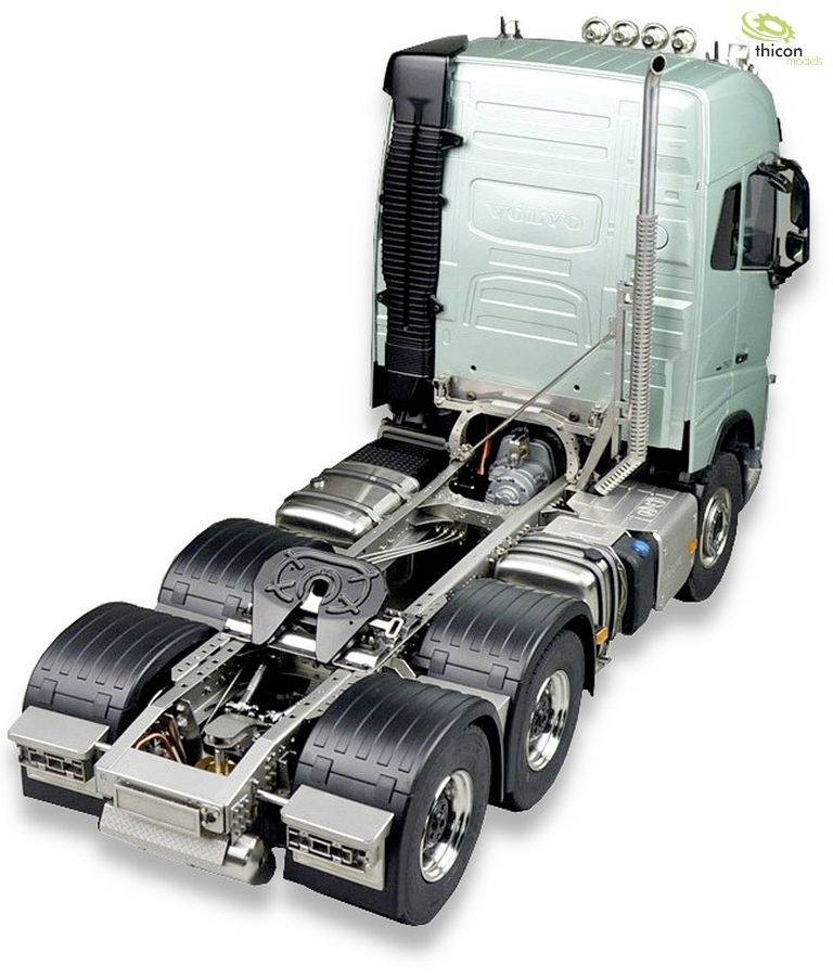 A silver lorry without a trailer, photographed from the side. Large tyres, an exhaust pipe, and the cab are visible.