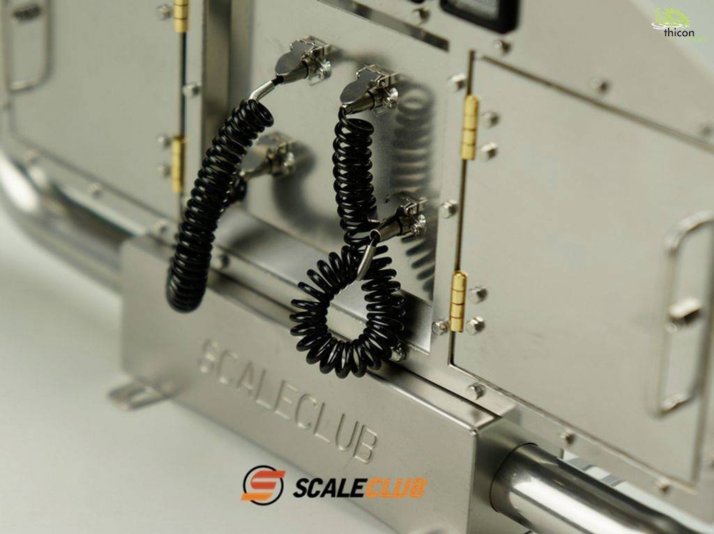Close-up of a silver metal device with two black spiral cables and an orange 'Scale Club' logo on the front.
