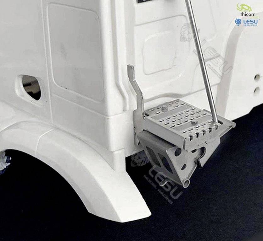 Model car with a detailed running board and suspension. The vehicle is finished in white and displays precise structural features.