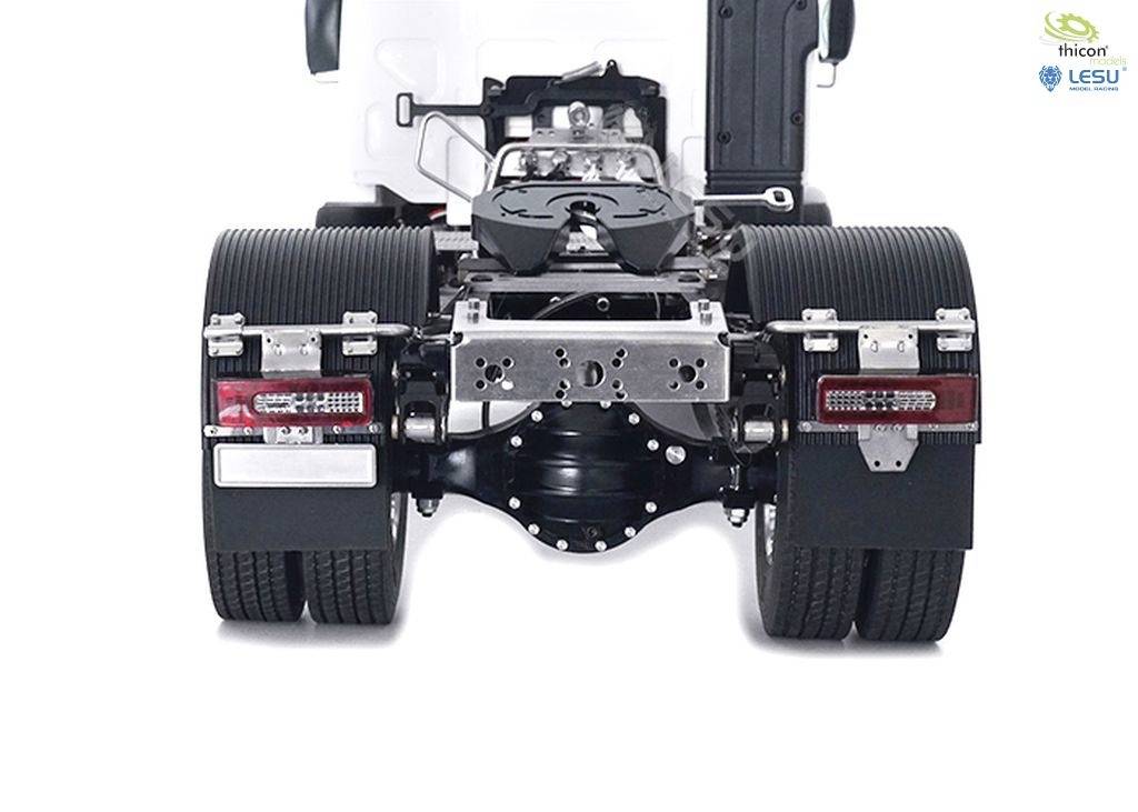 Rear view of a white lorry without a trailer, clearly showing the tyres, rear lights, and chassis connection points.