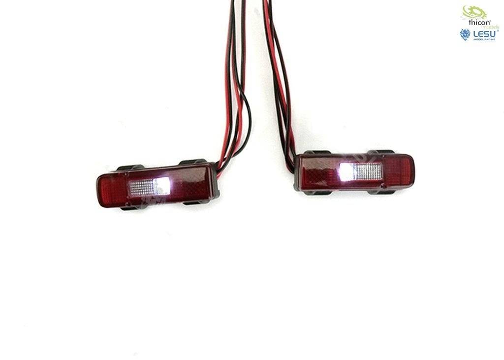 Two red LED lights with black frames and cables on a white background, ready for installation or connection.