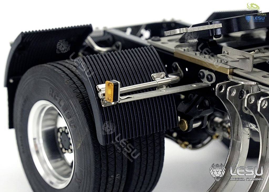 A model vehicle chassis with detailed structures and a large tyre. Focus on suspension and wheel construction.