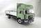 Green MAN lorry with open cargo area, photographed against a neutral background.