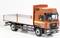 An orange lorry model with a red cab and an open cargo bed is positioned sideways on a white background.
