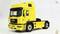 Yellow model of a MAN lorry with detailed driver's cab and distinctive chassis, presented on a neutral background.