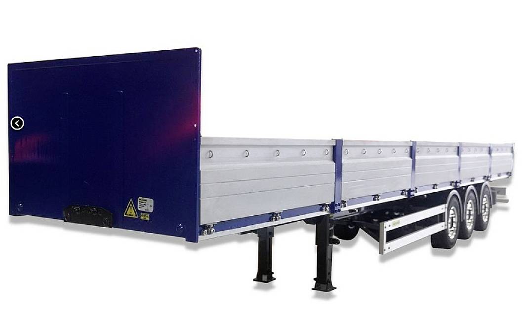 A blue, three-axle trailer with high side walls, suitable for goods transportation. Front view shows markings.