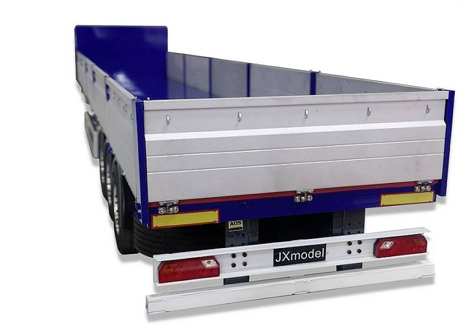 A blue open trailer with high side walls and reflective strips. Tyres are visible in the background.