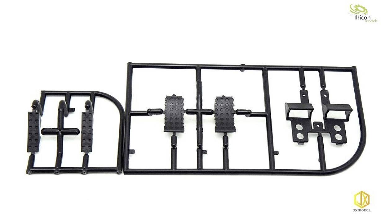 A die-cast frame with small black plastic parts in an orderly arrangement, presumably model components from thicon models.