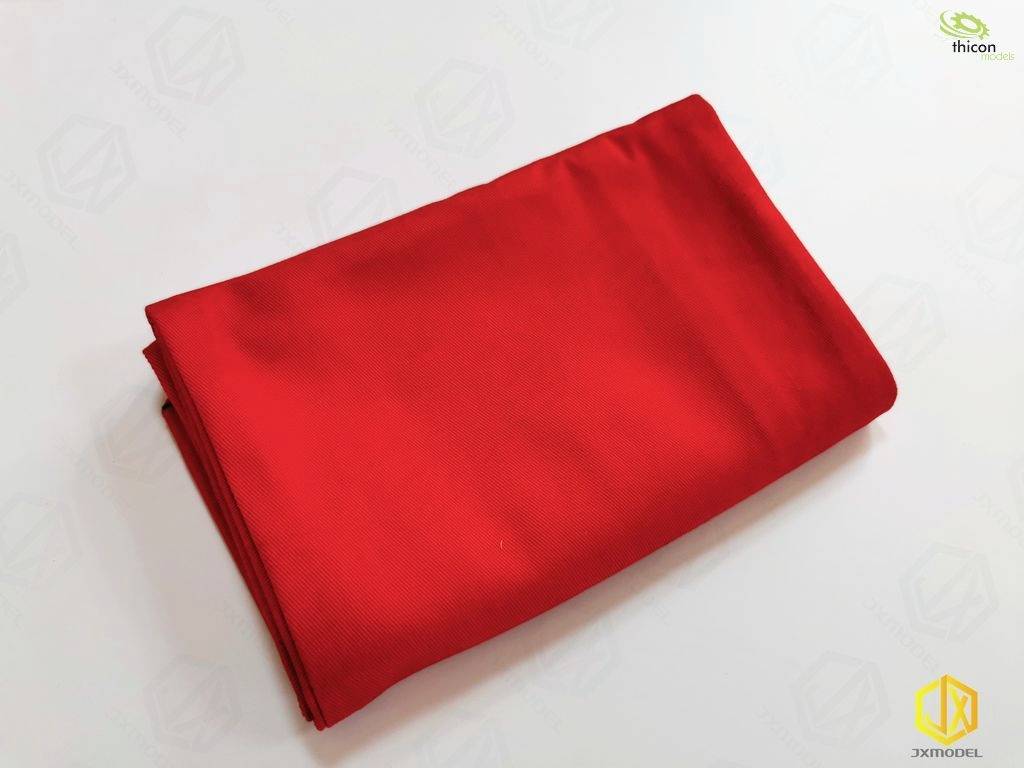 Red, smoothly folded fabric on a light background.