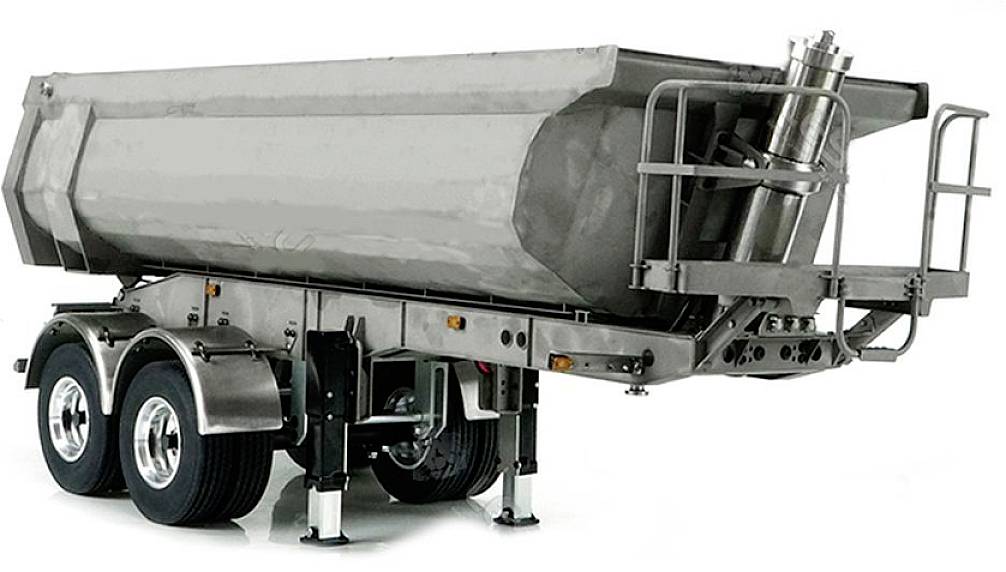 A silver tipping trailer with two axles, extended stabilisers and a closed loading area, stands upright on a white background.