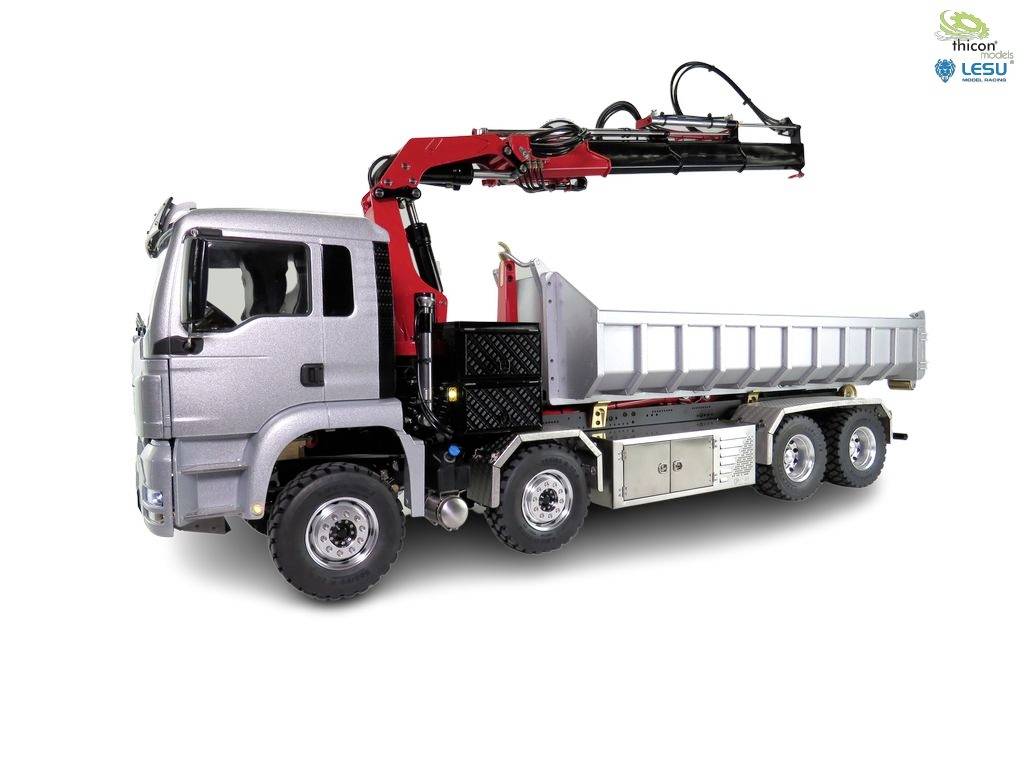 Silver lorry with red crane arm on the loading bed, six wheels and robust design, positioned sideways.