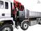 Silver lorry with red crane and open cargo area, photographed from the side; technical details of the construction visible.