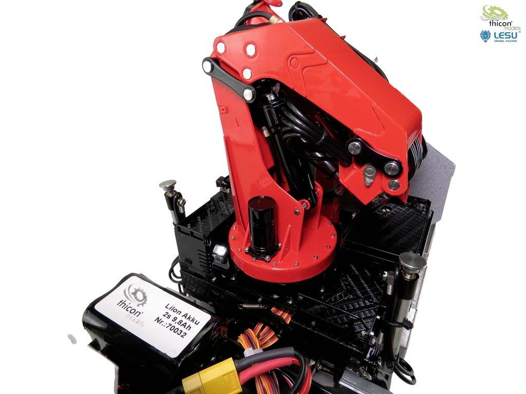 A red mechanical arm on a black base, surrounded by cables and electronic components. The logos of 'ithcor' and 'LESU' are visible.